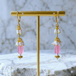 Handmade pink bead and white pearl drop earrings with gold-toned lever back hoops.