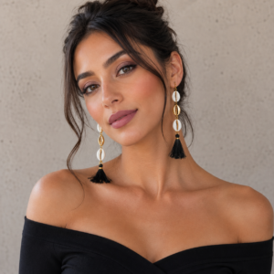Long black tassel earrings with white and 18 K Gold plated cowrie shells on brass hooks.