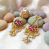 Royal purple Kundan statement chandelier earrings with anti-tarnish brass base and intricate pearl tassels for festive celebrations.